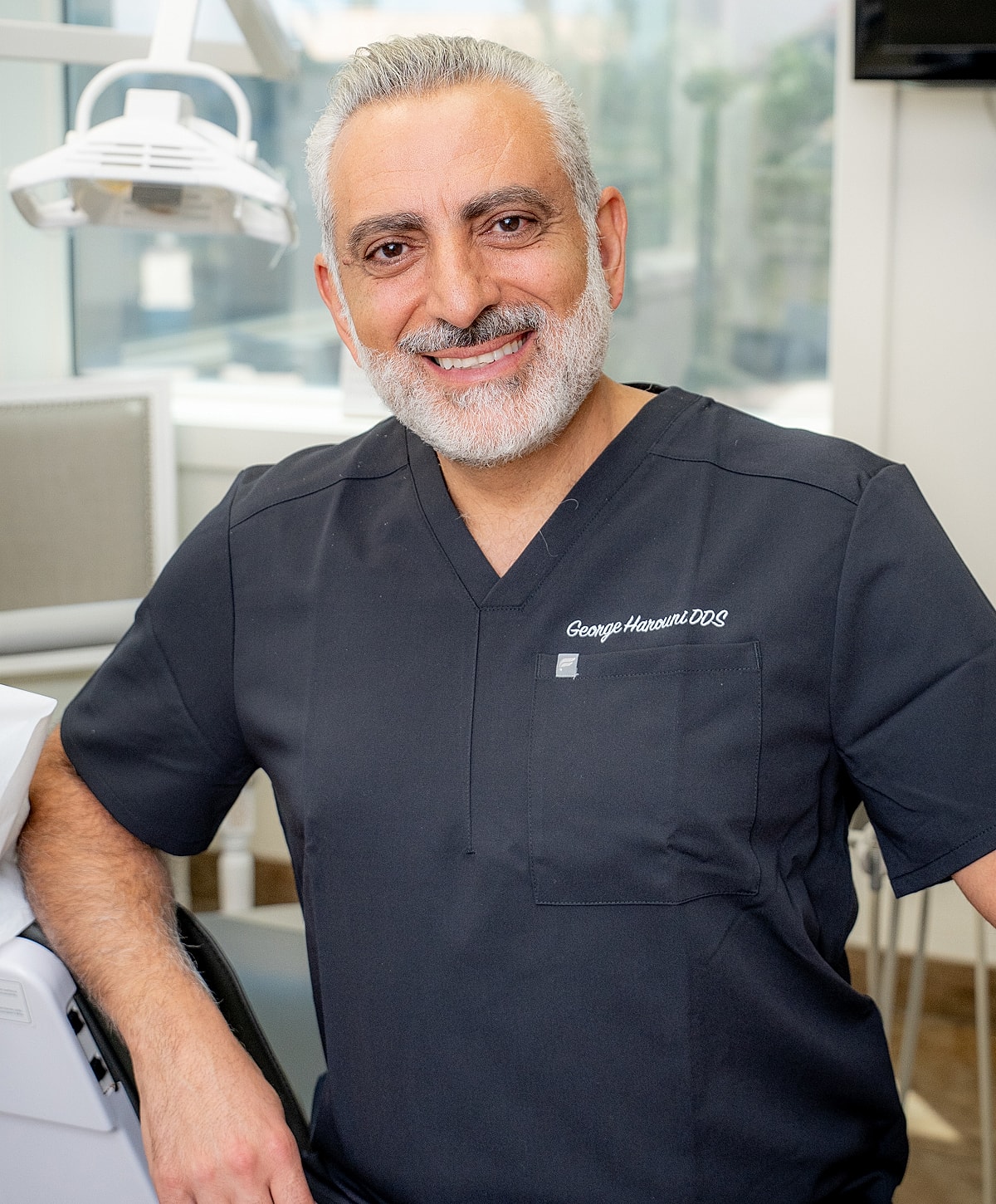 Smiling dentist in professional attire in office.