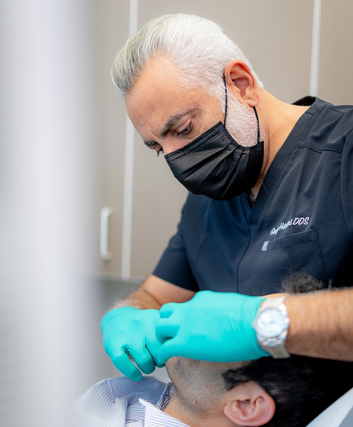 Dentist examining patient's mouth with gloves.