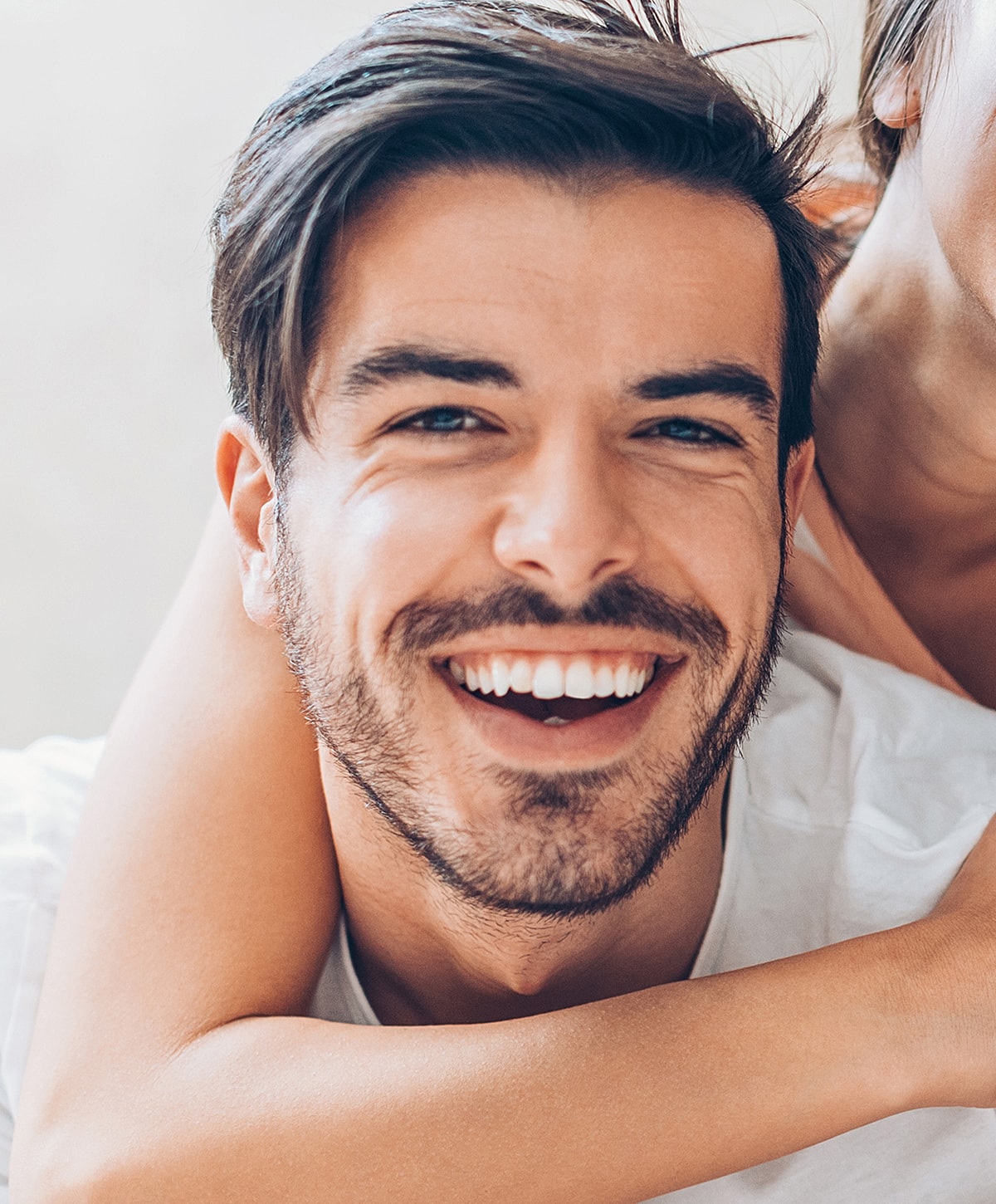 Smiling man with short hair and beard.