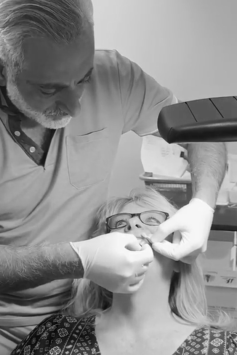 Dentist treating patient in dental office.