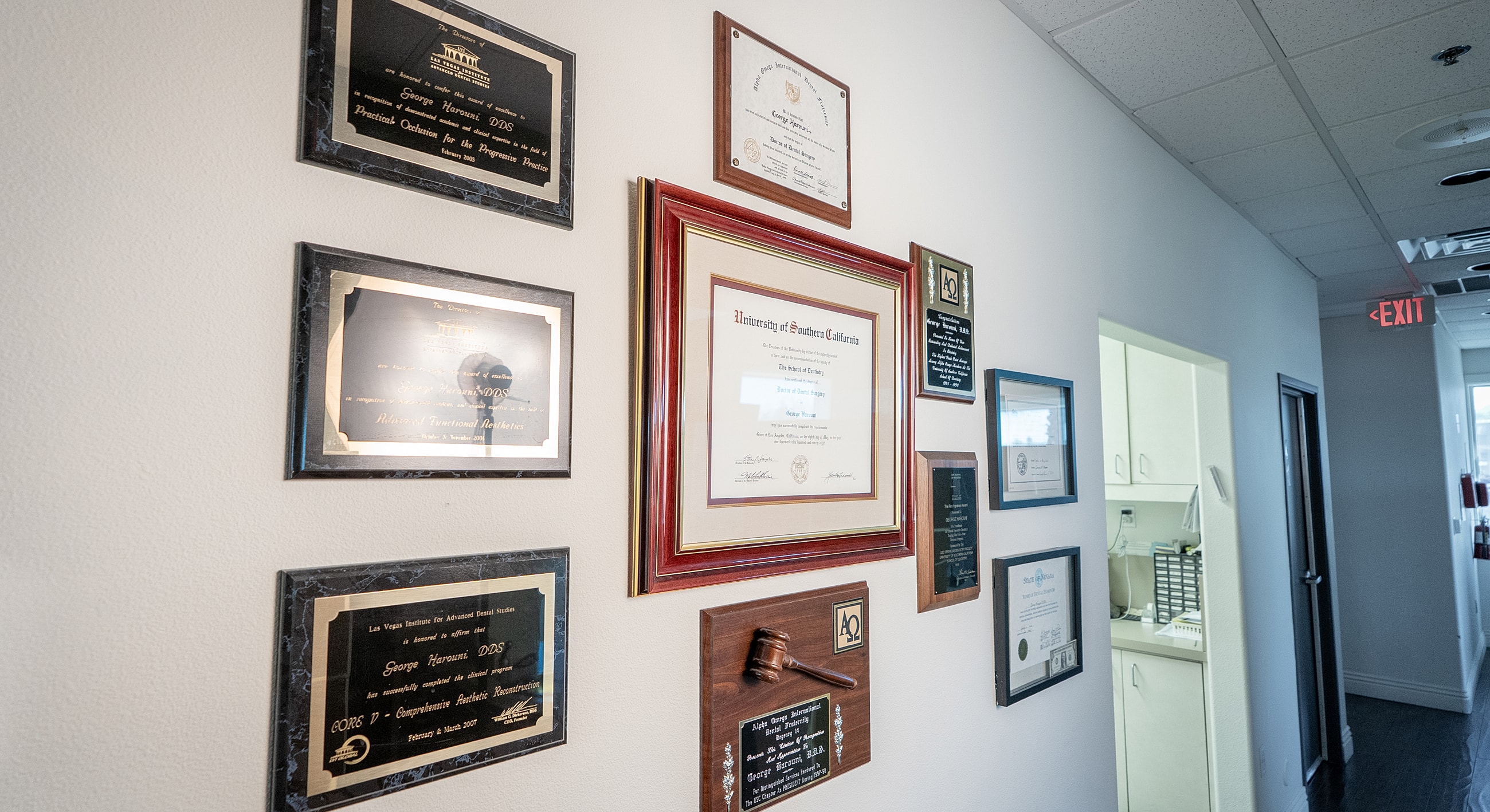 Wall display of diplomas and awards.