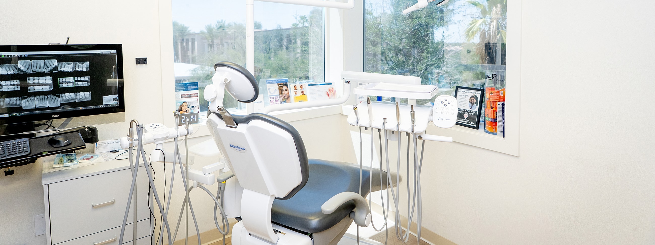Dental examination room with equipment and x-rays.