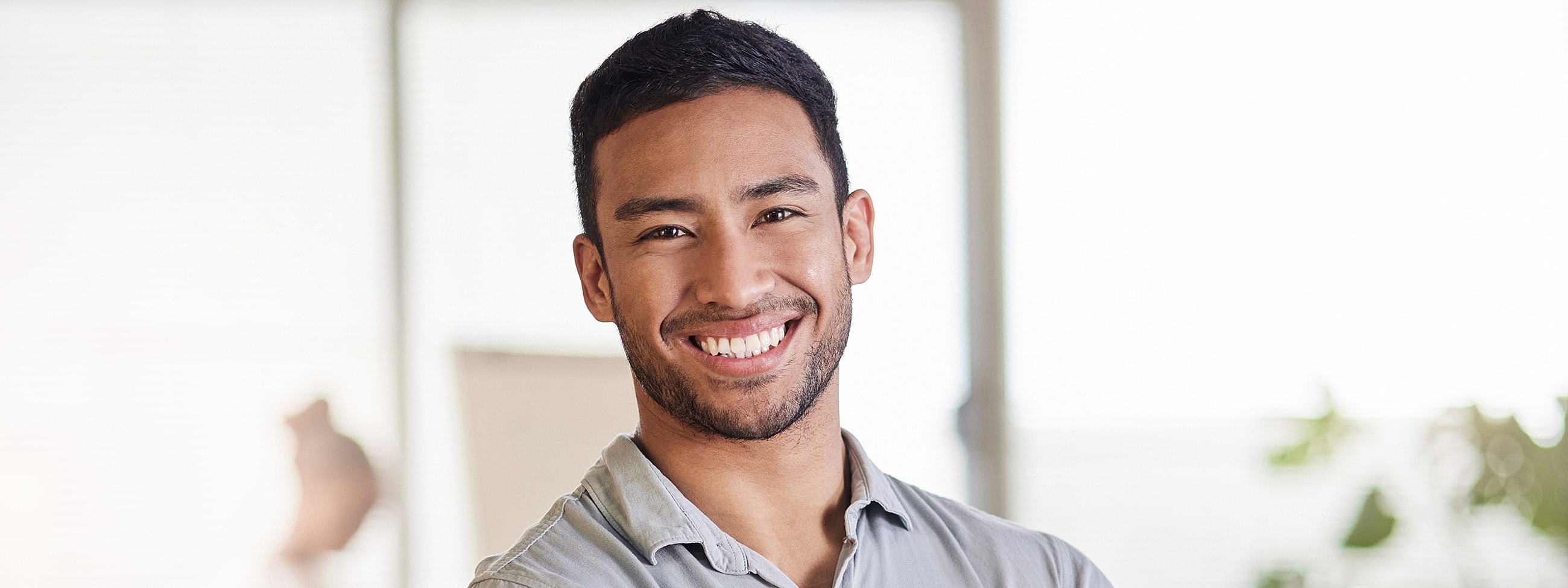Smiling man in a light-colored shirt.